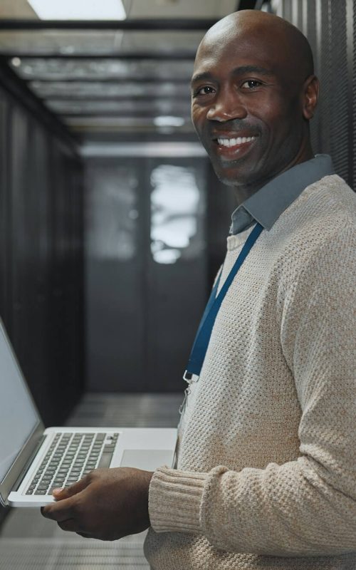 server-room-laptop-and-man-portrait-or-technician-for-data-center-system-and-cybersecurity-code-.jpg