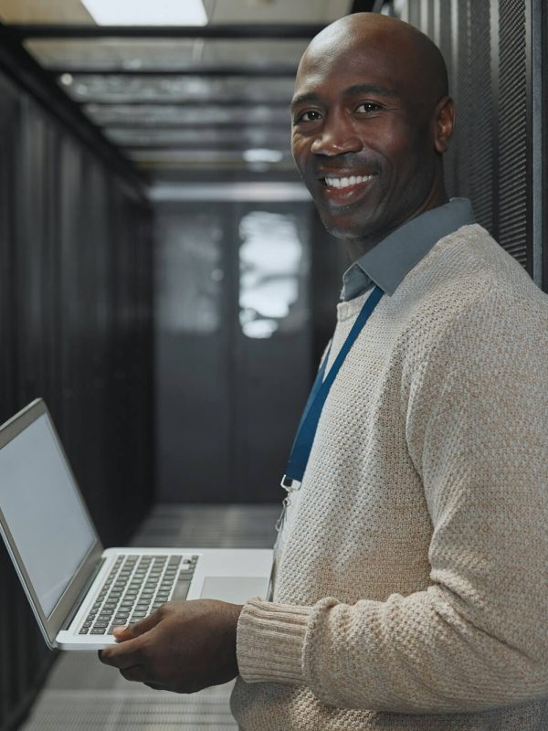 server-room-laptop-and-man-portrait-or-technician-for-data-center-system-and-cybersecurity-code-.jpg